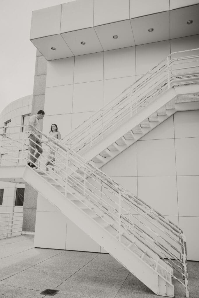 couple walking down stairs black and white photo