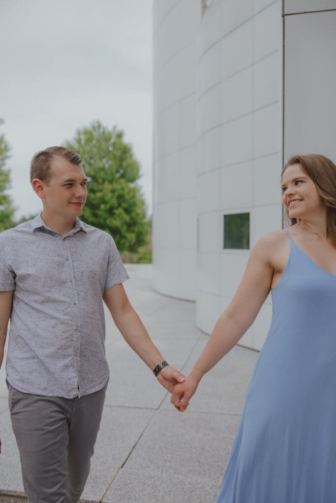 couple holding hands walking relaxing mt pleasant iowa session