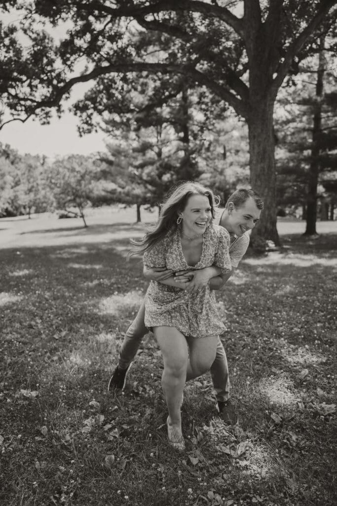black and white couple photo outdoors laughing