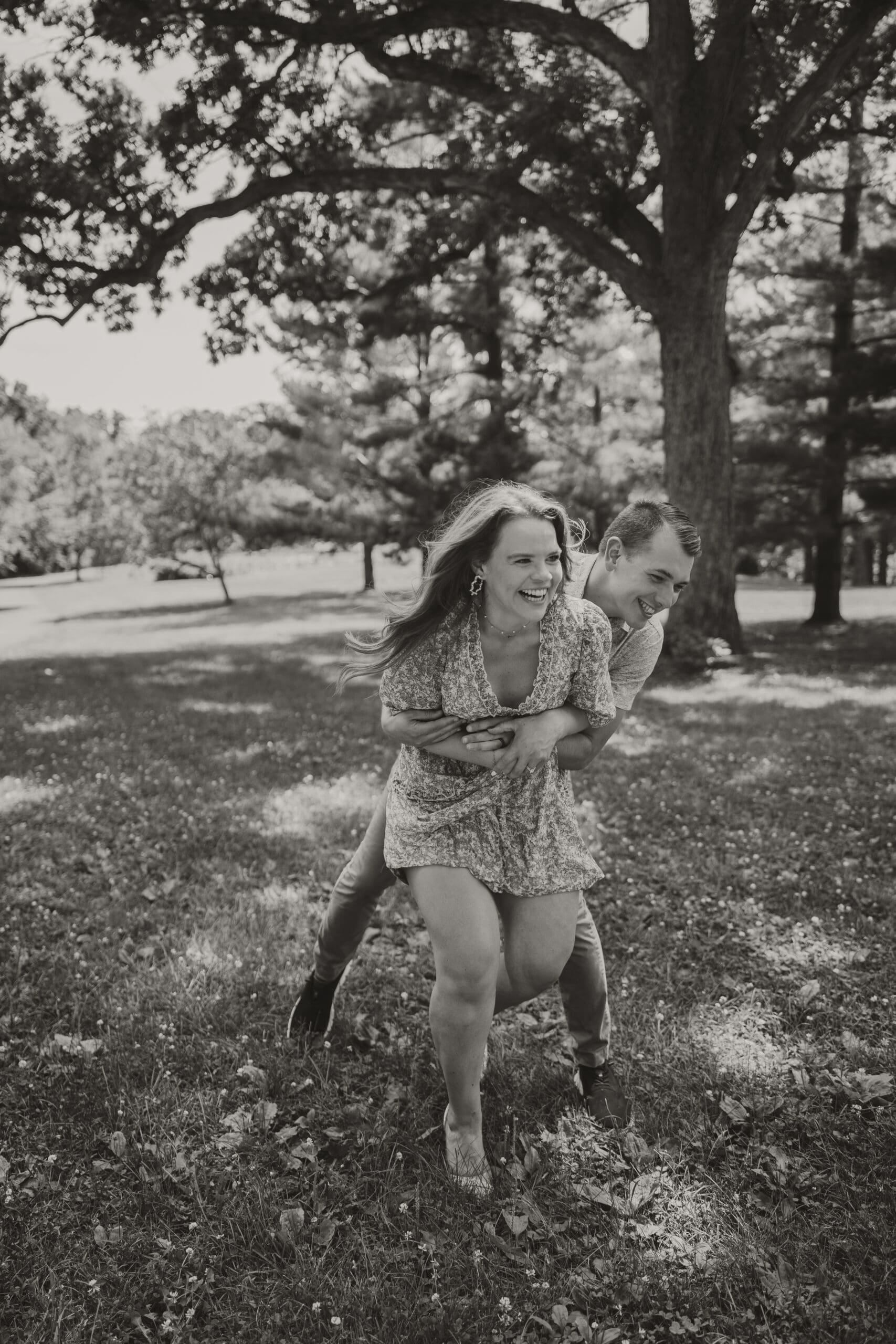 black and white couple photo outdoors laughing