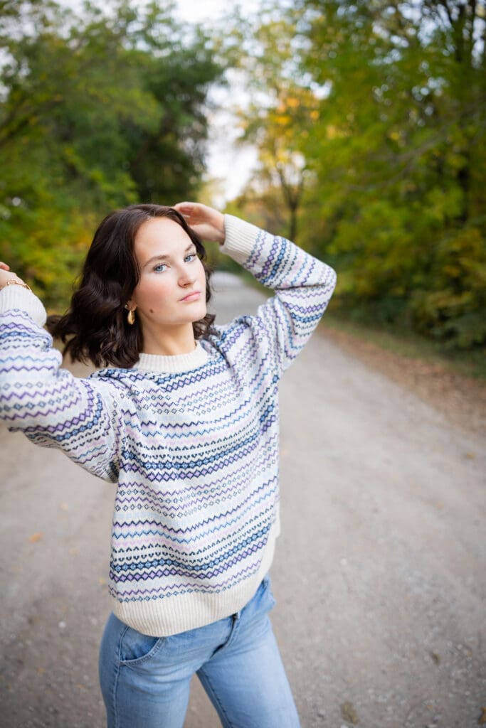 girl in sweater on gravel road
