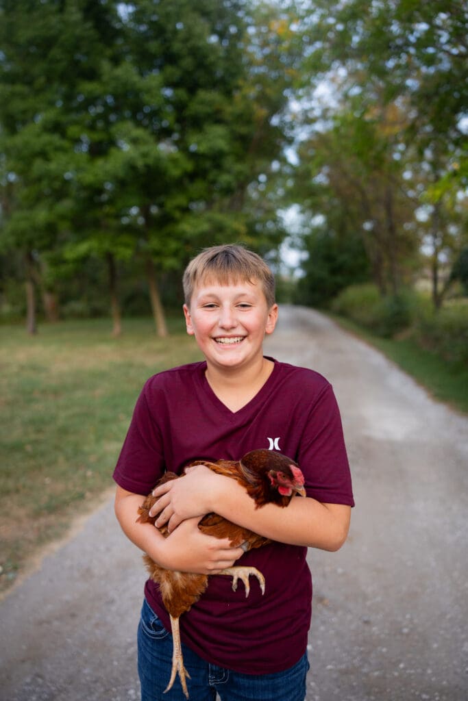 Younger son smiling during outdoor Iowa family session.