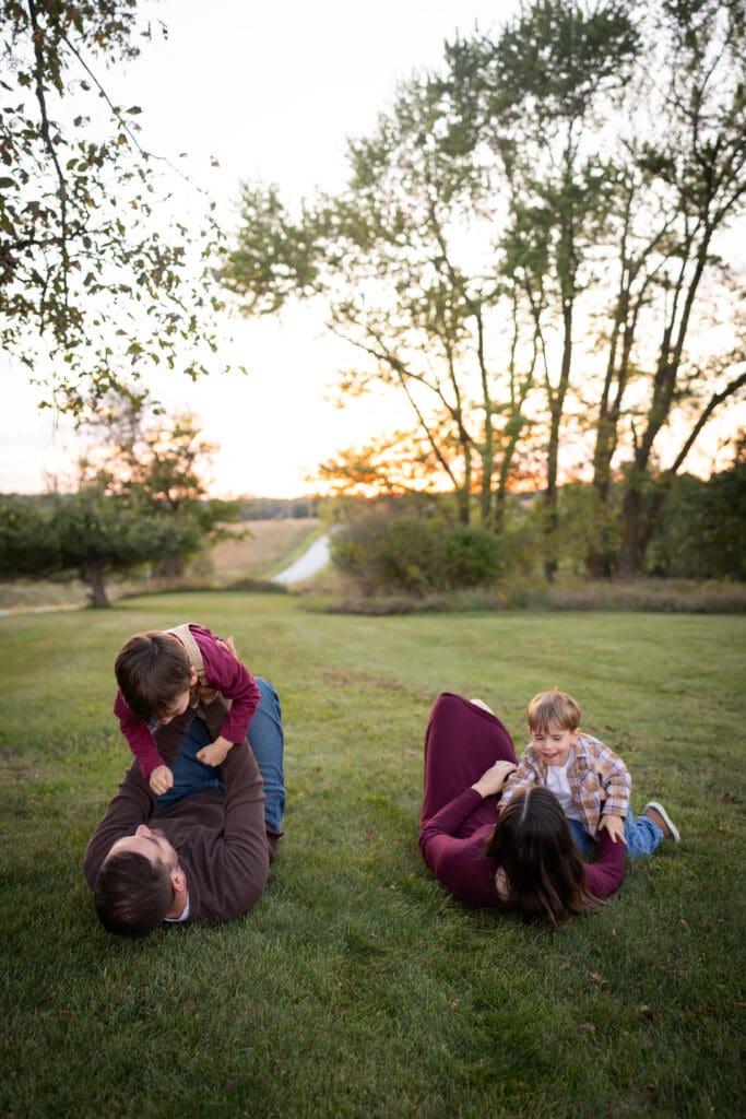 Family Playing in the grass at sunset