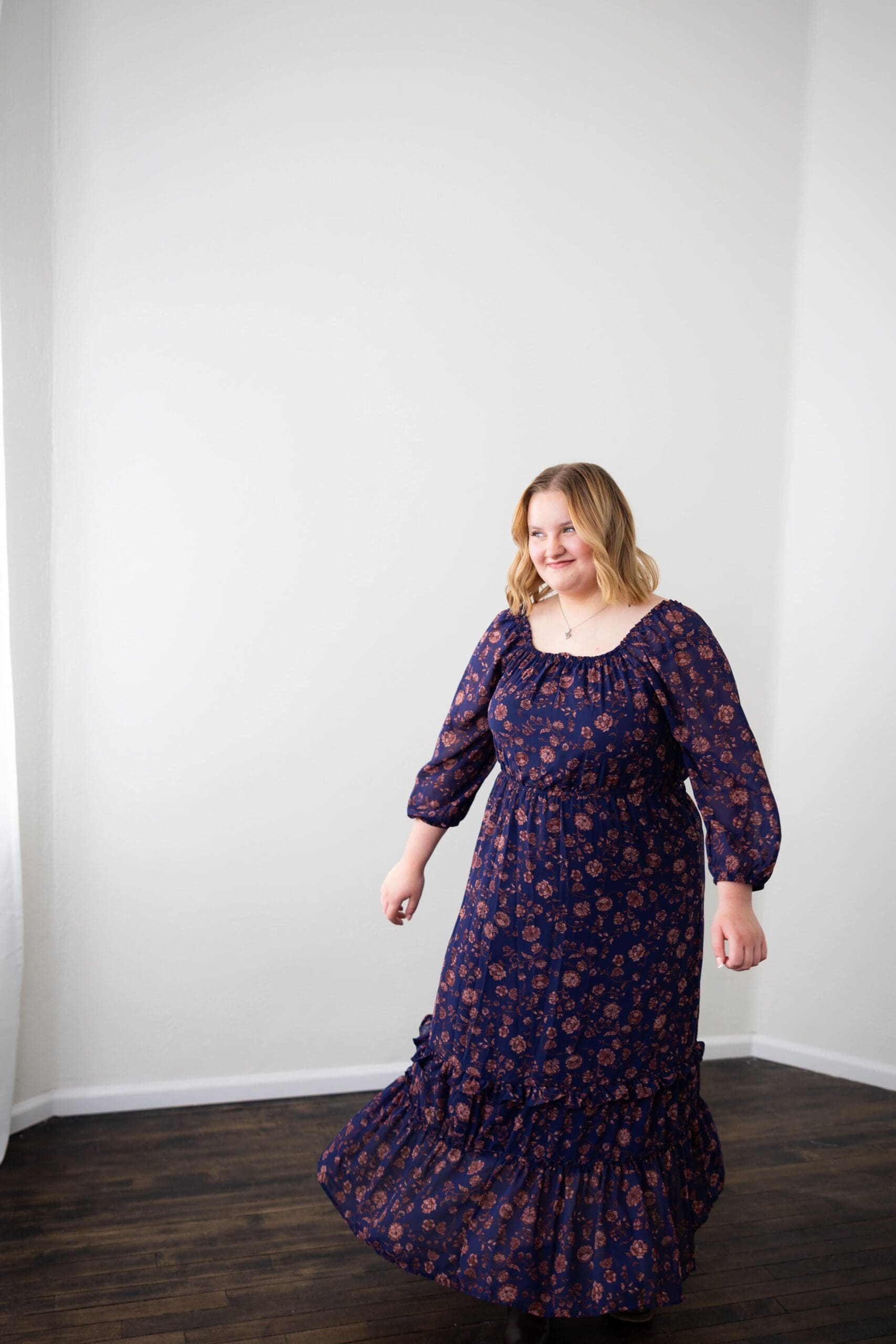 studio senior girl session twirling in her floral dress