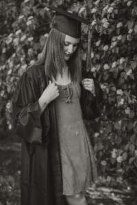 Black and White 2026 Senior Girl Cap and Gown Photo Floral background