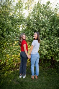 Bestie College Tee Photo Outdoors Floral Backdrop Iowa Senior Photographer Turned around smiling