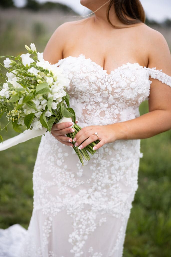bride in white dress with white flowers