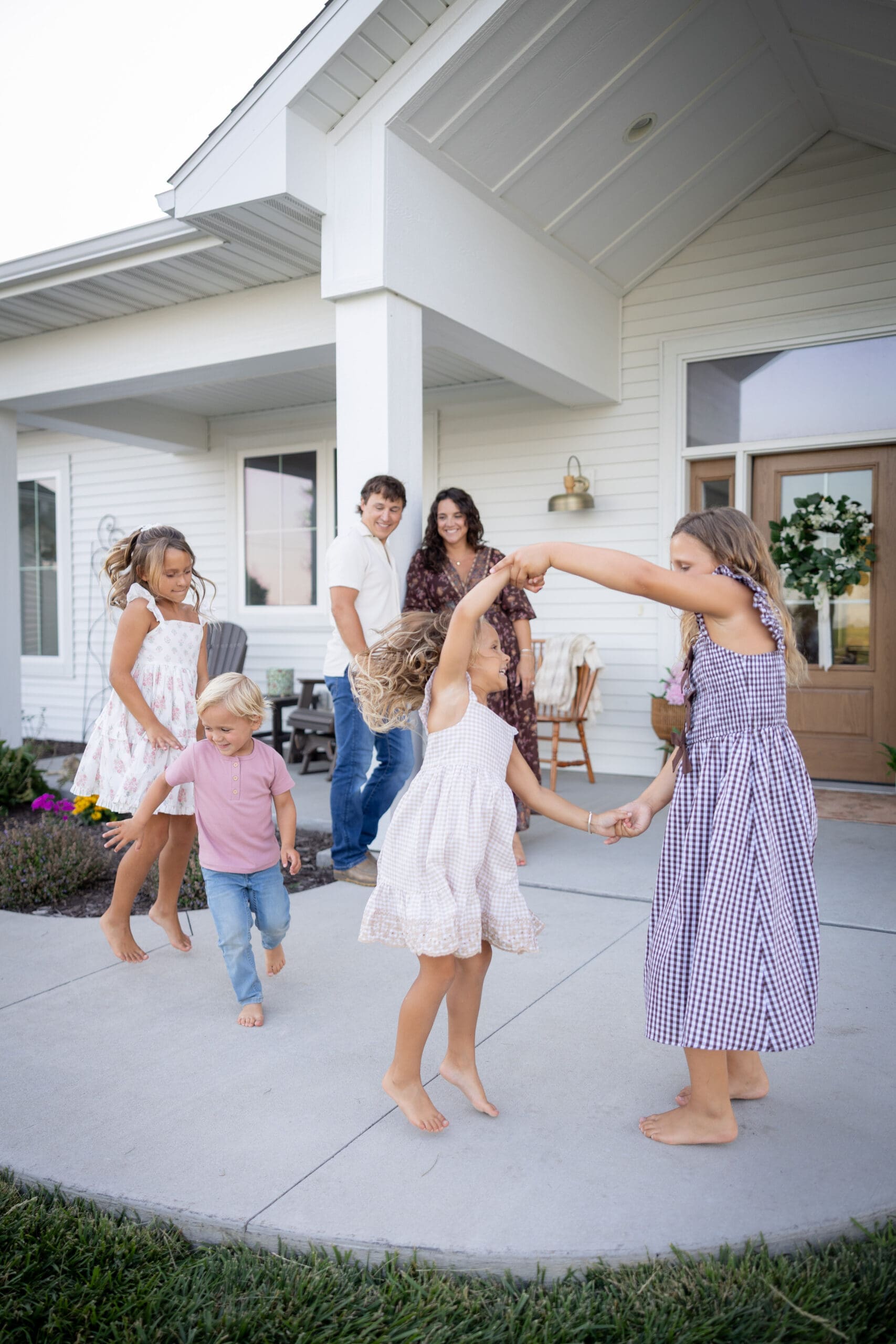 family dancing on front porch together