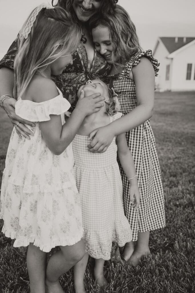 Mom and daughters hugging